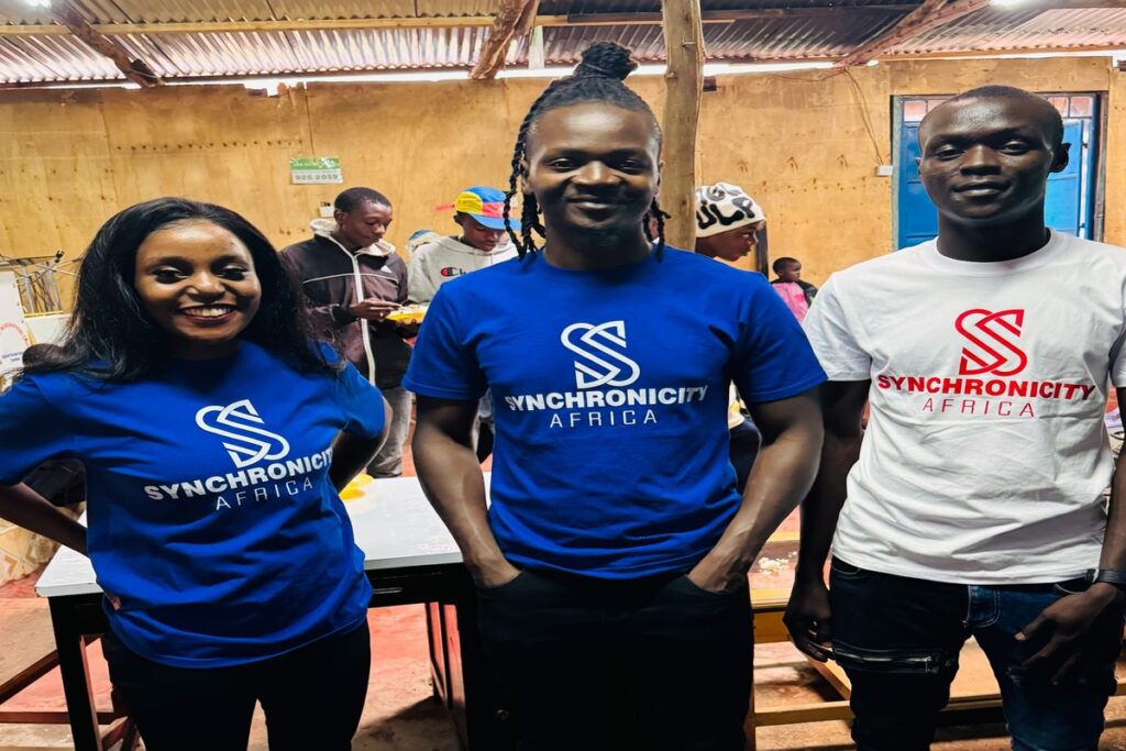 Synchronicity Africa team participating in street children feeding program in Korogocho slums in Nairobi